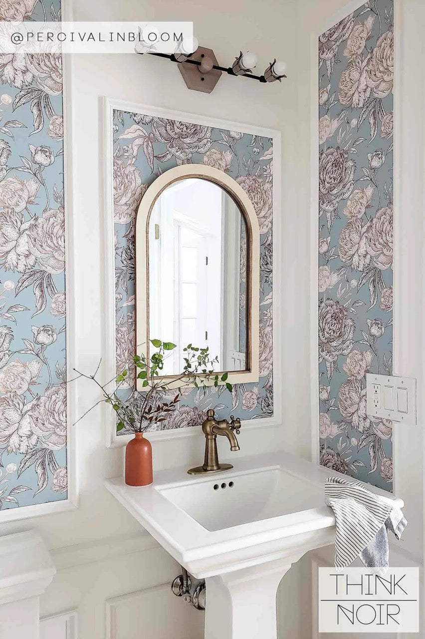 A modern vintage-inspired bathroom featuring Think Noir wallpaper.