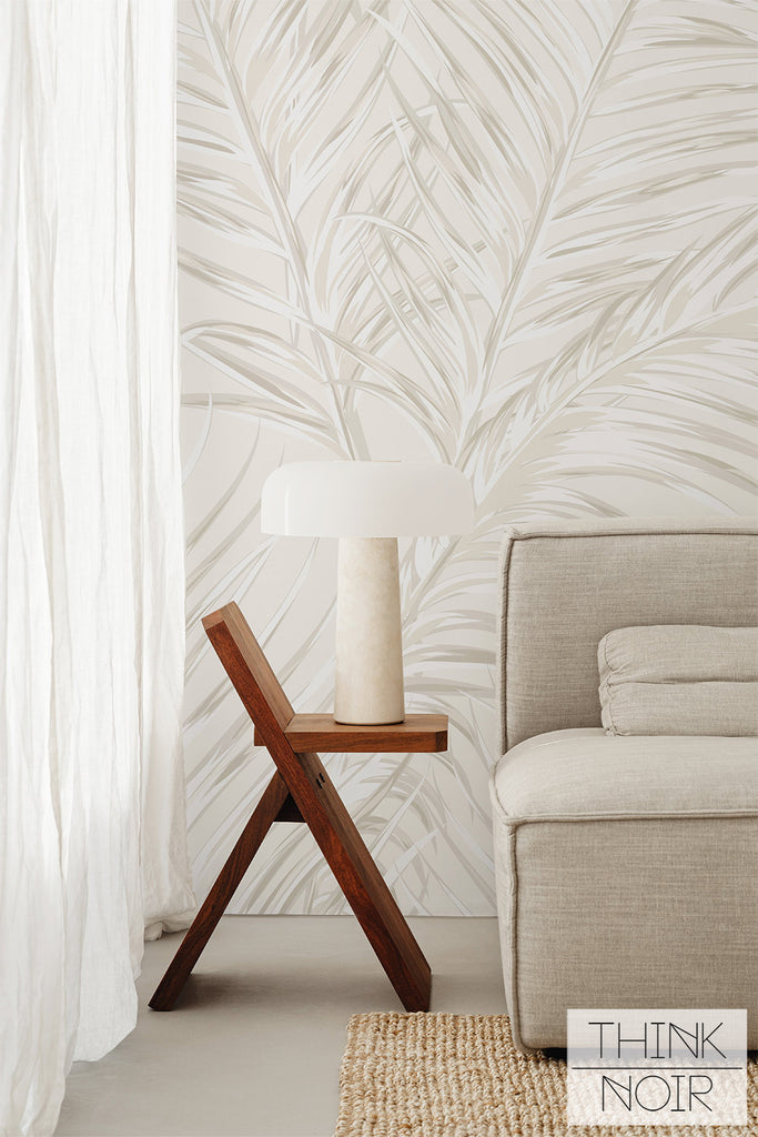 soft and neutral living room design with large palm leaves motif wallpaper