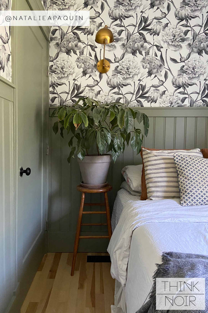moody bedroom interior with green paneling and grey peony wallpaper